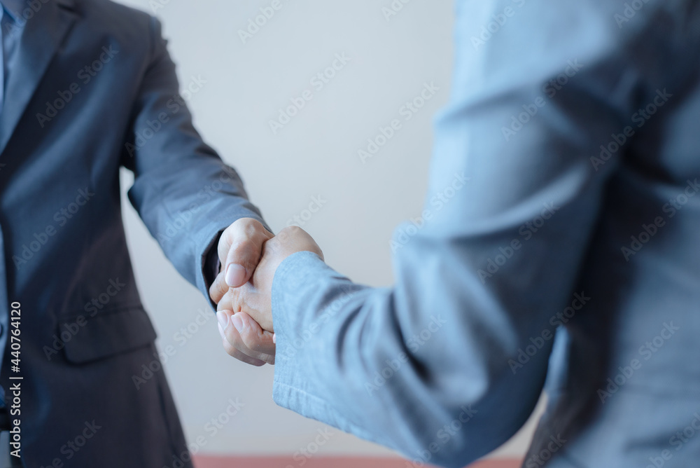 Fototapeta premium business man and business woman shaking hands for success deal a partnership together. friendship hand shake greeting.