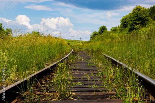Railway on a background of green grass and sky © Cigor