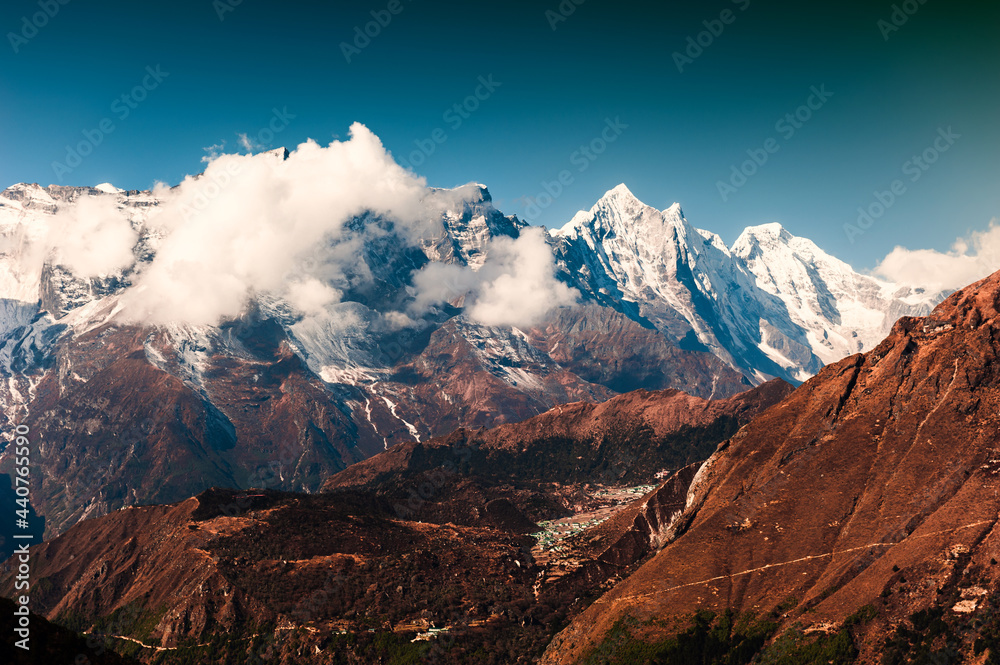 View of Himalaya mountains with clouds. Khumbu valley, Everest region, Nepal. Beautiful autumn landscape