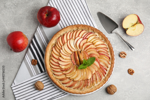 Flat lay composition with delicious homemade apple tart on grey table photo