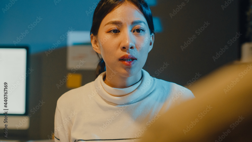 Fototapeta premium Happy young Asia businessmen and businesswomen meeting brainstorming some new ideas about project to his partner working together planning success strategy enjoy teamwork in small modern night office.