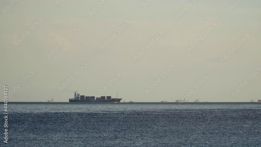 Shipping containers cargo logistics businesses services import and export sailing on Manila Bay. Shipping containers cargo logistics businesses services import and export sailing on Manila Bay.