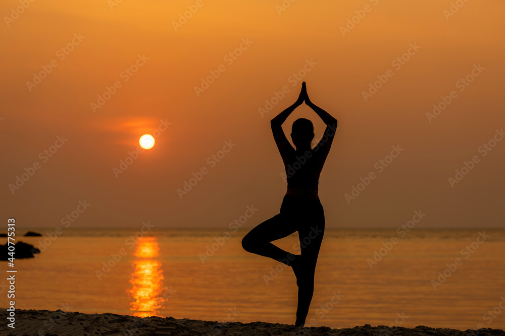 Silhouette lifestyle woman yoga exercise for healthy life.  Young girl or people pose balance body vital zen and meditation workout and fitness sport outdoor sunset near the beach