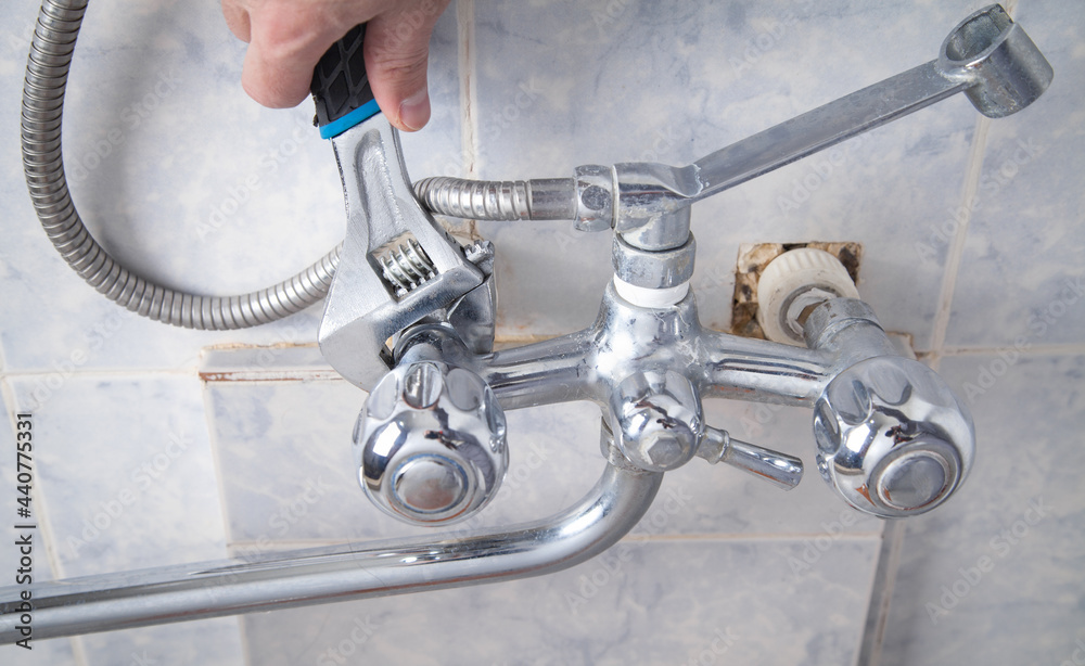 Man repair and fixing shower faucet in bathroom. Man repair and fixing shower faucet in bathroom.