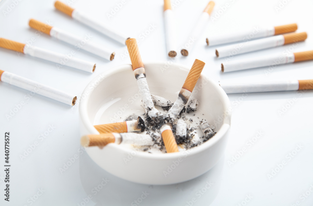 White ashtray with a cigarette. Smoking White ashtray with a cigarette. Smoking