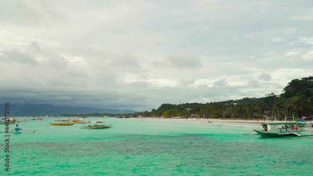 Sandy beach with tourists among turquoise waters. Philippines Boracay. Travel concept Sandy beach with tourists among turquoise waters. Philippines Boracay. Travel concept
