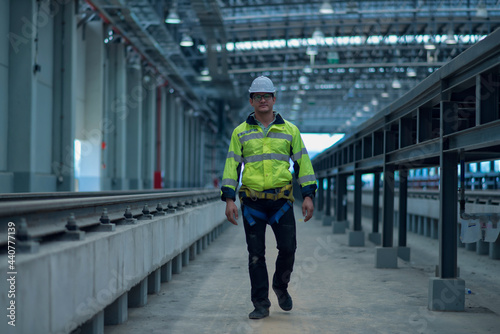 person in a subway station. Worker in hand hold check sheet inspection job. Worker work in factory.