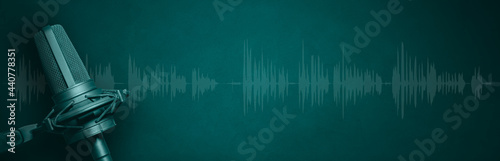 Vocal microphone and audio waveform on green banner background. Broadcast radio, sound recording or podcasting banner with copy space
