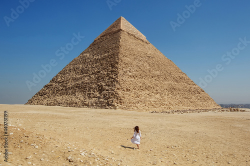Beautiful woman near the ancient pyramids of Egypt
