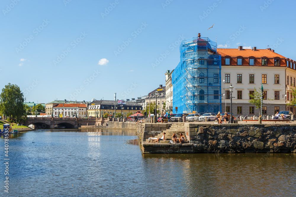 Naklejka premium Canal in Gothenburg with sunbathing people