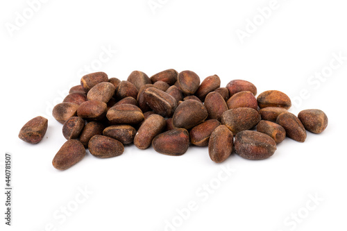 Fresh unpeeled cedar nuts isolated on white background, closeup
