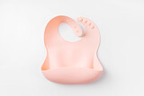 Pink silicone baby bib on white background. Top view, flat lay