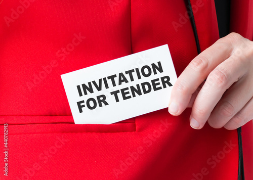 Closeup on businessman holding a card with text INVITATION FOR TENDER, business concept