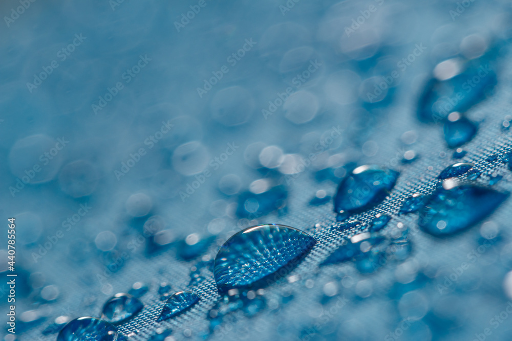 Rain droplets on a blue waterproof fabric background,close up Rain droplets on a blue waterproof fabric background,close up