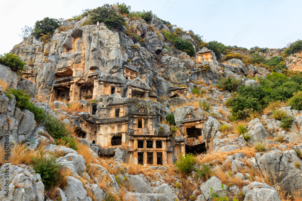 Fototapeta premium Rock-cut tombs of Lycian necropolis of the ancient city of Myra in Demre, Antalya province in Turkey