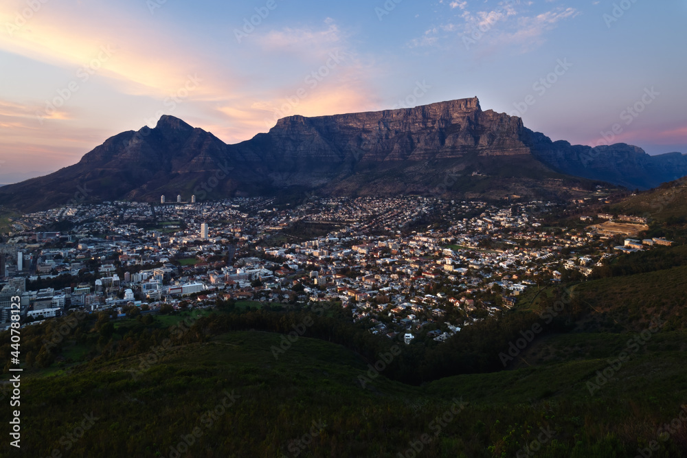 The winter sun rises over Cape Town and Table Mountain in South Africa.