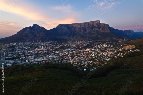 The winter sun rises over Cape Town and Table Mountain in South Africa.