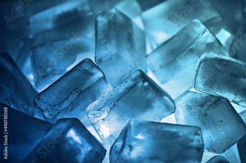 Frozen ice cubes on the dark blue to cyan gradient light.