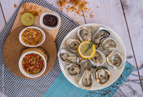 Oyster and side dishes in Thai style with spicy dipping sauce. photo