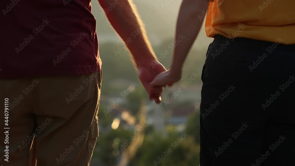 A man and a woman hold hands, but then they quarrel and push each other away. Close up. Rear view. Real time. A man and a woman hold hands, but then they quarrel and push each other away. Close up. Rear view. Real time.