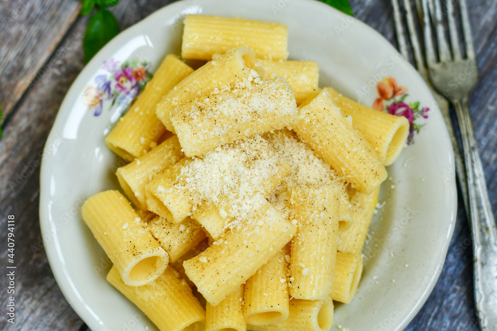 Home made italian rigatoni pasta with parmesan cheese,garlic and black pepper .Pasta cacio e pepe. Mediterranean food concept Home made italian rigatoni pasta with parmesan cheese,garlic and black pepper .Pasta cacio e pepe. Mediterranean food concept