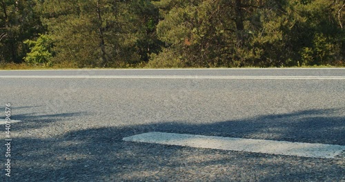 forest road and cars in summer in slow motion