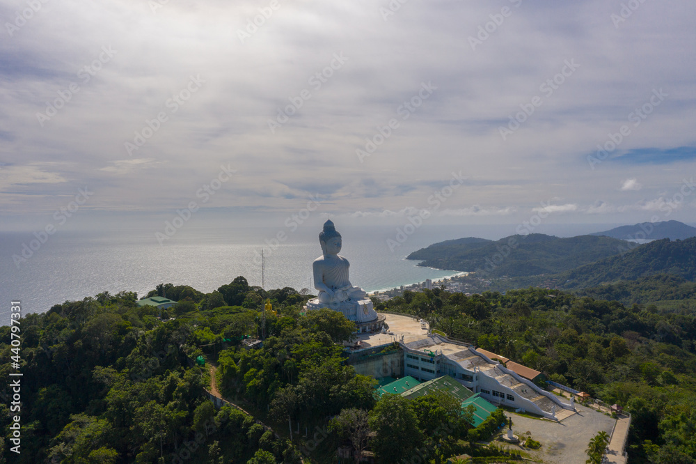 aerial photography Phuket big Buddha in sunny day.Phuket Big Buddha is one of the most important and revered landmarks on Phuket island..white cloud in blue sky, blue sea and mountain background