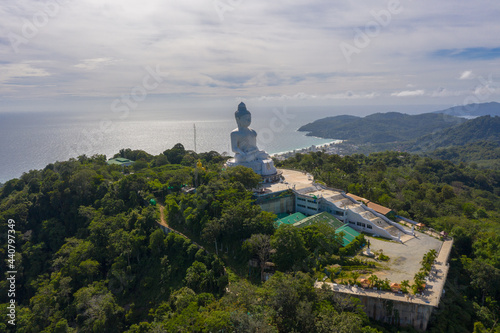 aerial photography Phuket big Buddha in sunny day.Phuket Big Buddha is one of the most important and revered landmarks on Phuket island..white cloud in blue sky, blue sea and mountain background