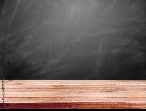 Blank wood table top with a chalkboard background.