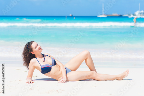 Beautiful girl laying on the beach in Caribbean