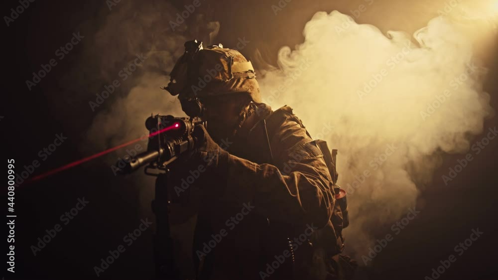 The operator is in full protective gear. Laser sight. Gloomy atmosphere