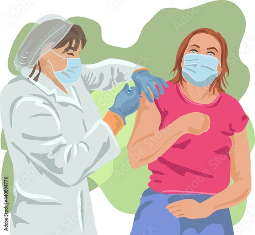 Doctor in a mask and robe vaccinates against coronavirus to a masked woman