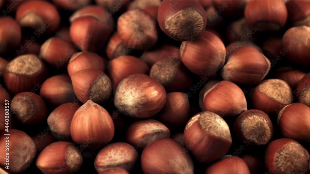 Super slow motion hazelnut falls into a heap. Macro background. Filmed on a high-speed camera at 1000 fps. Super slow motion hazelnut falls into a heap. Macro background. Filmed on a high-speed camera at 1000 fps.