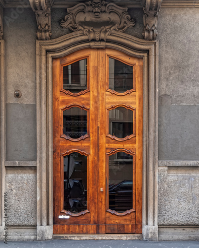 Italy Milan, vintage residential house entrance wood and glass door