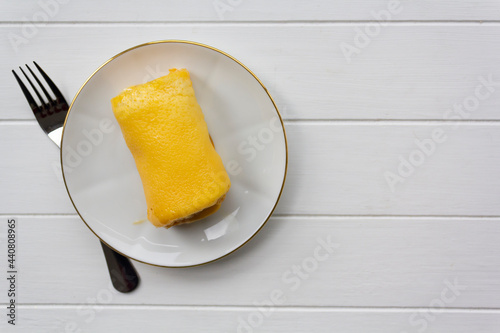Traditional portuguese sweet called Torta de Azeitao on white wooden table with copy space