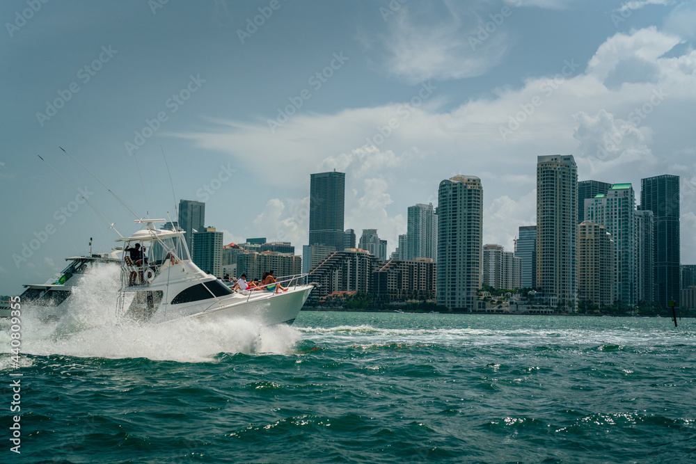 Fototapeta premium boat in the city sea lifestyle party family buildings skyline panorama Miami Florida summer yacht blue urban ocean 