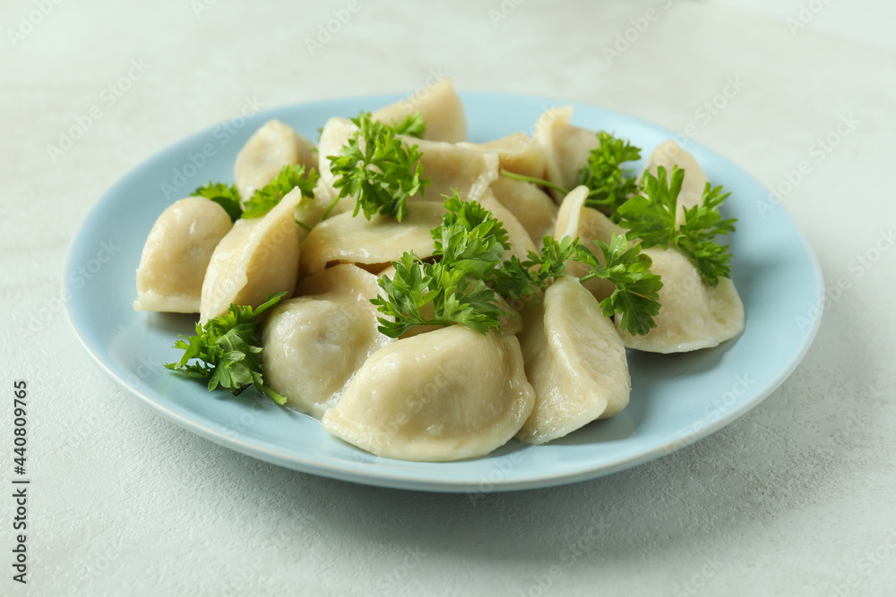Concept of tasty food with vareniki or pierogi on white textured table Concept of tasty food with vareniki or pierogi on white textured table