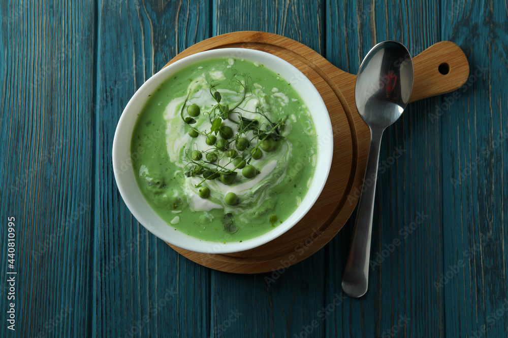 Concept of tasty eating with pea soup on wooden table Concept of tasty eating with pea soup on wooden table