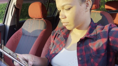 happy and beautiful african american woman with short hair in a car, lifestyle