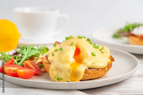 Eggs Benedict on toasted muffins with bacon. hollandaise sauce
