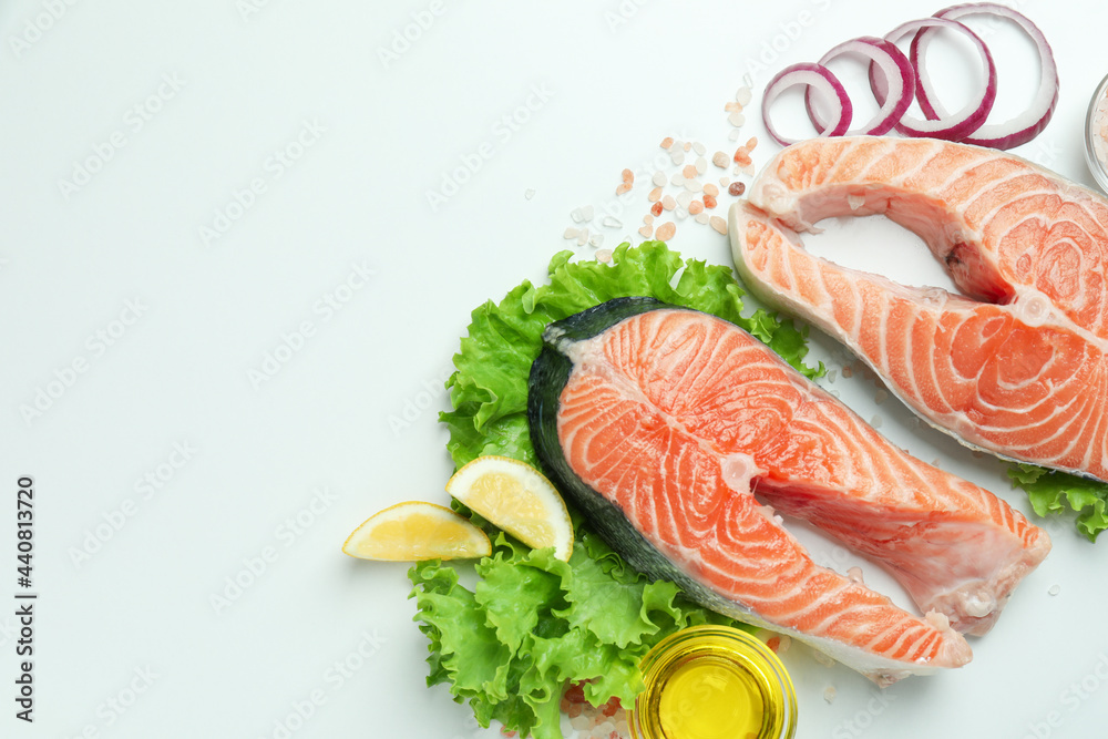 Fresh raw salmon and ingredients for cooking on white background Fresh raw salmon and ingredients for cooking on white background