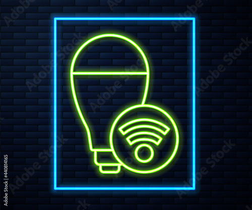 Glowing neon line Smart light bulb system icon isolated on brick wall background. Energy and idea symbol. Internet of things concept with wireless connection. Vector