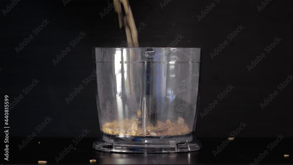Oatmeal is poured into a blender Oatmeal is poured into a blender