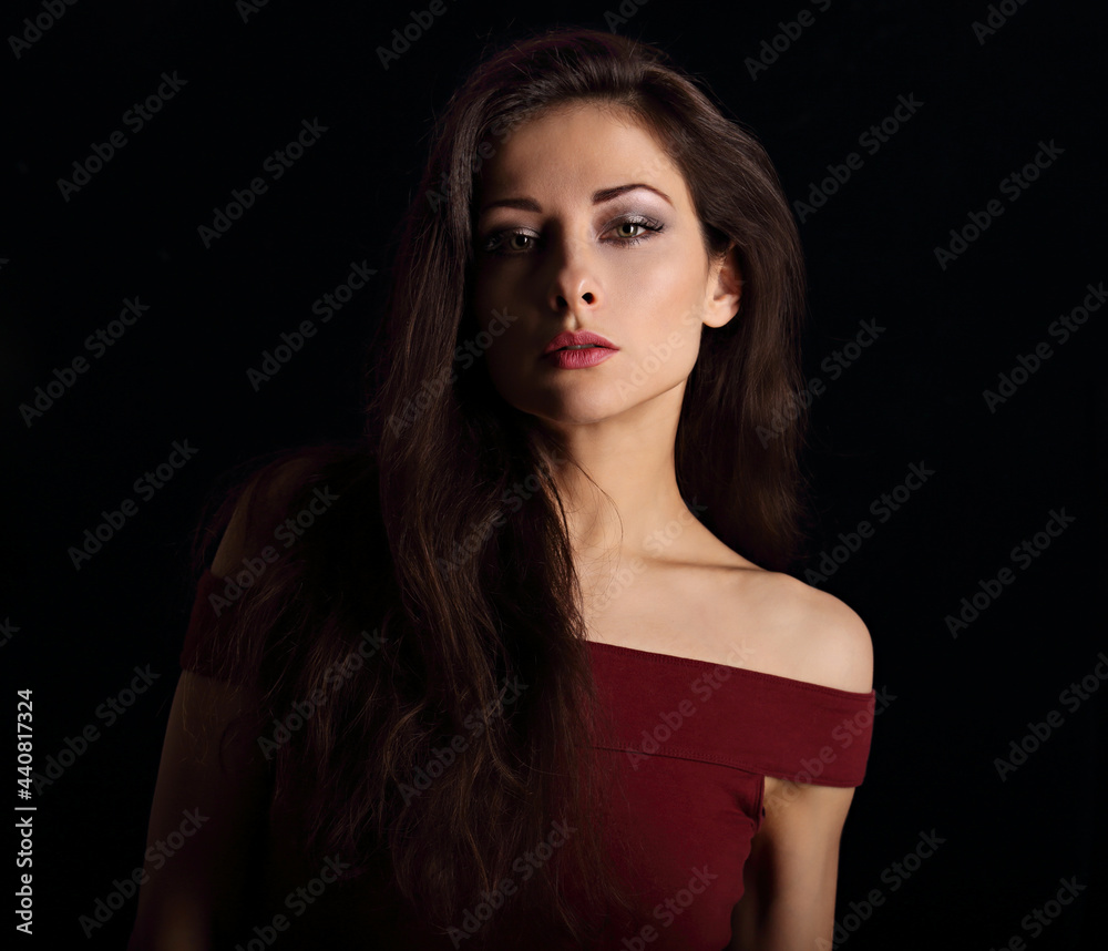 Beautiful mysterious woman makeup face with wisdom emotional look on dramatic shadow black background with empty copy space. Closeup