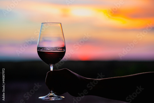 Sunset with a glass of wine.Beautiful sky with sunset with a glass of wine.A glass of wine at sunset in the mountains.Red wine. Relax.Summer concept.Summer with sunset.August. Summer vacation 