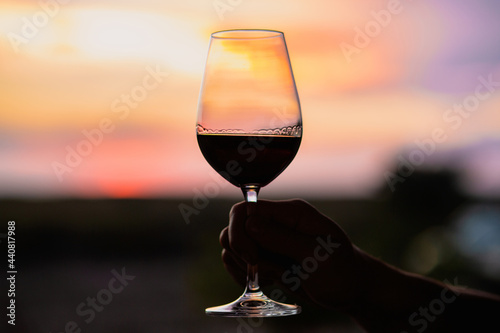 Sunset with a glass of wine.Beautiful sky with sunset with a glass of wine.A glass of wine at sunset in the mountains.Red wine. Relax.Summer concept.Summer with sunset.August. Summer vacation