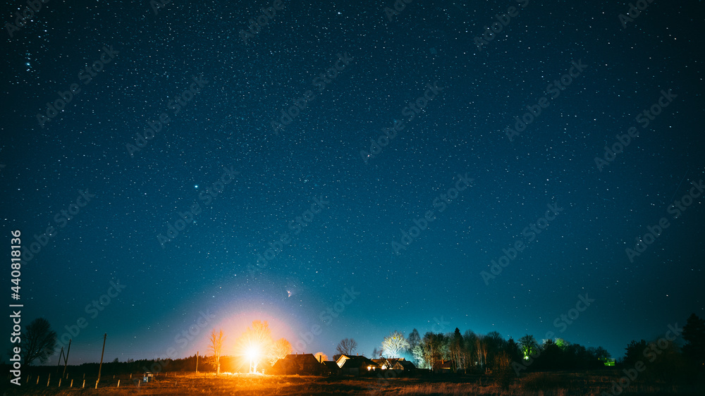 Real Night Sky Stars Above Old Village. Natural Starry Sky Above Rural Landscape In Belarus