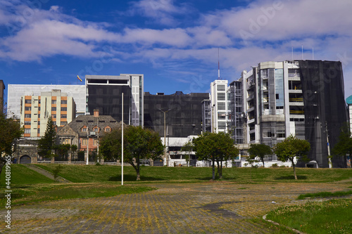 Nature and buildings, city ​​buildings surrounded by trees from adjoining parks