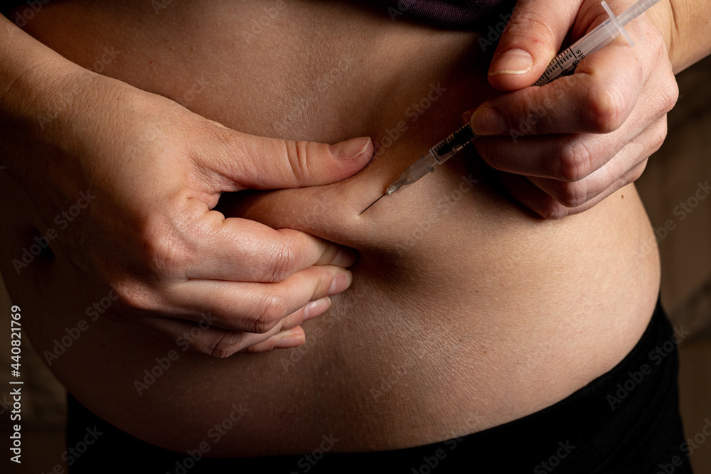 Injection of insulin into abdomen, stomach of pregnant women from syringe, diabetes Injection of insulin into abdomen, stomach of pregnant women from syringe, diabetes