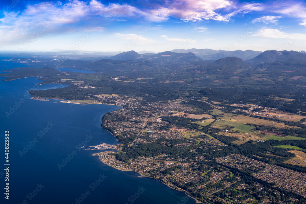 Aerial View of Qualicum Beach from an Airplane on the shore of Strait of Georgia in Vancouver Island, British Columbia, Canada. Colorful Blue Sky Art Render.